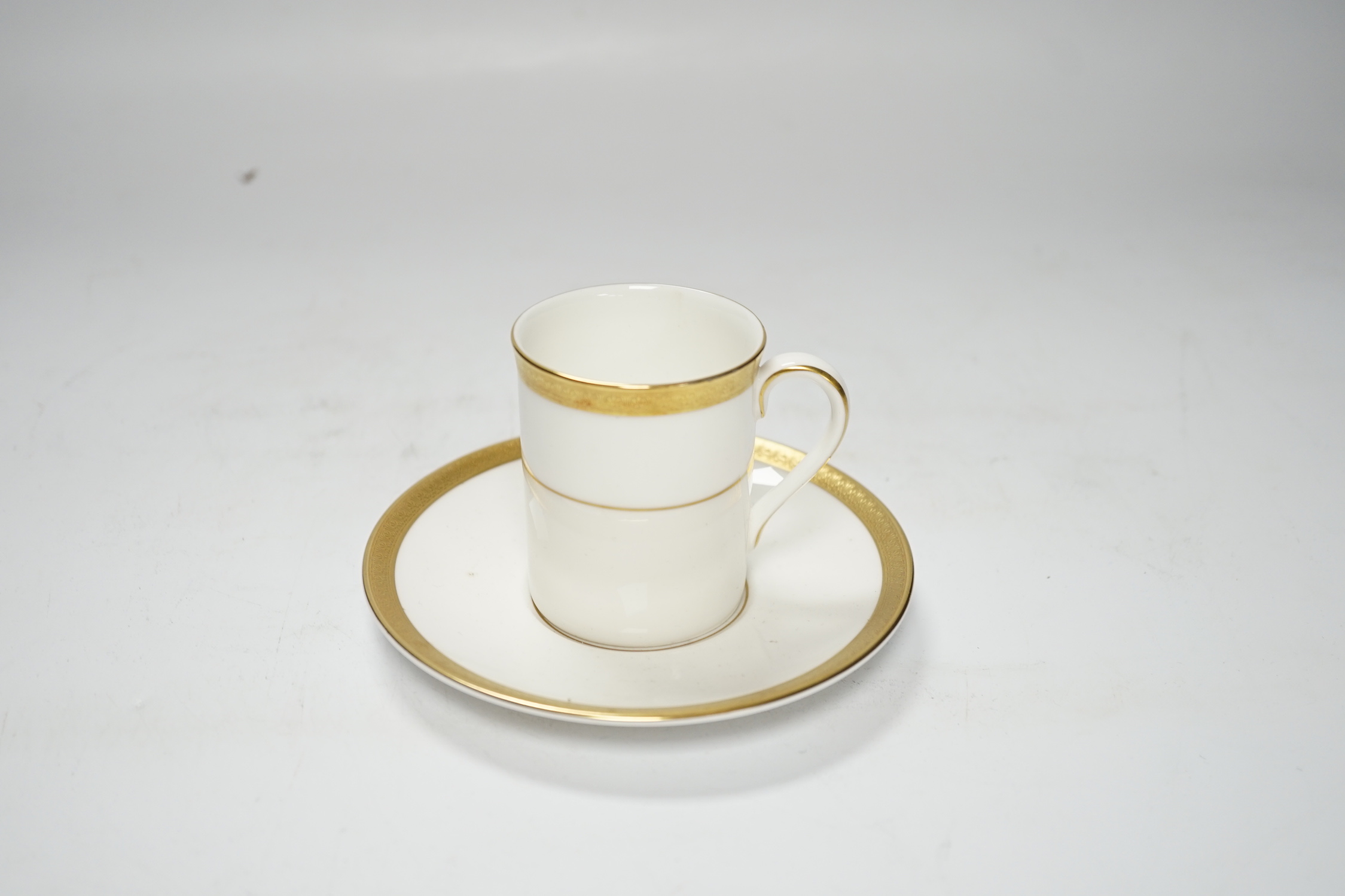 A cased Royal Doulton Royal gold pattern set of coffee cans and saucers